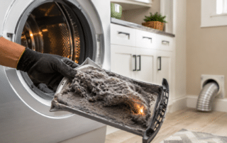 Dryer Maintenance: 5 Essential Fire Prevention Tips – Smooth Repair Services Dryer Maintenance showing a gloved hand removing heavy lint buildup from a clothes dryer filter